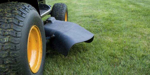 Ground level closeup of a ride on mower  - shallow DoF